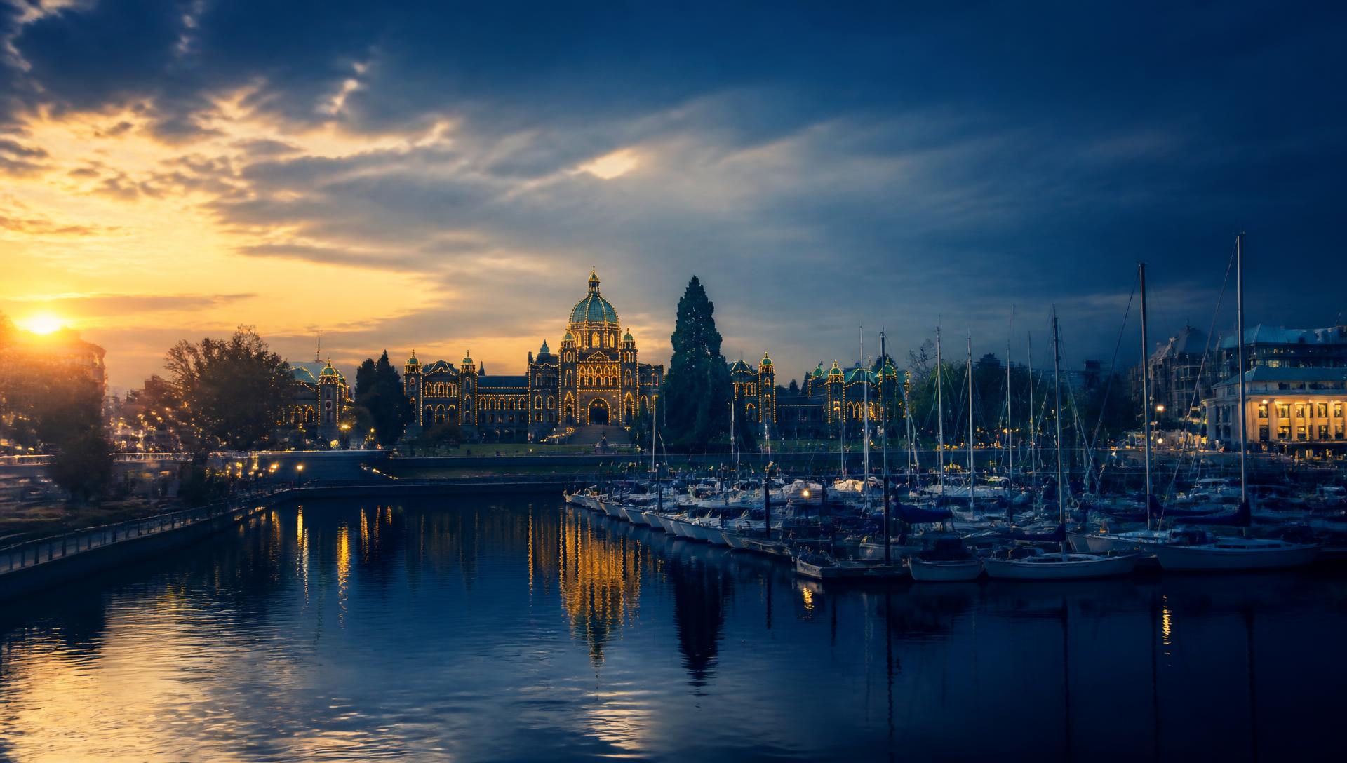 Victoria, British Columbia inner harbour at dusk with the legislature lit up
